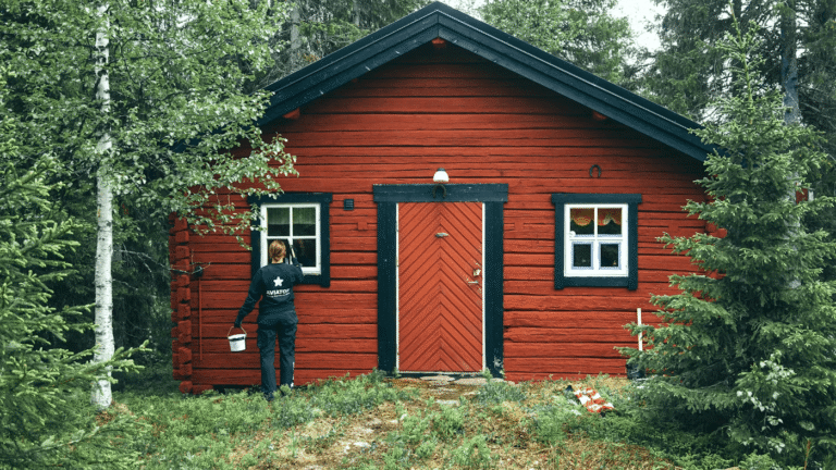 small cabin being painted red